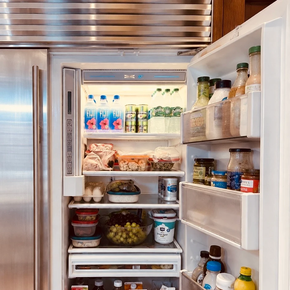Open stainless steel refrigerator with freezer drawers